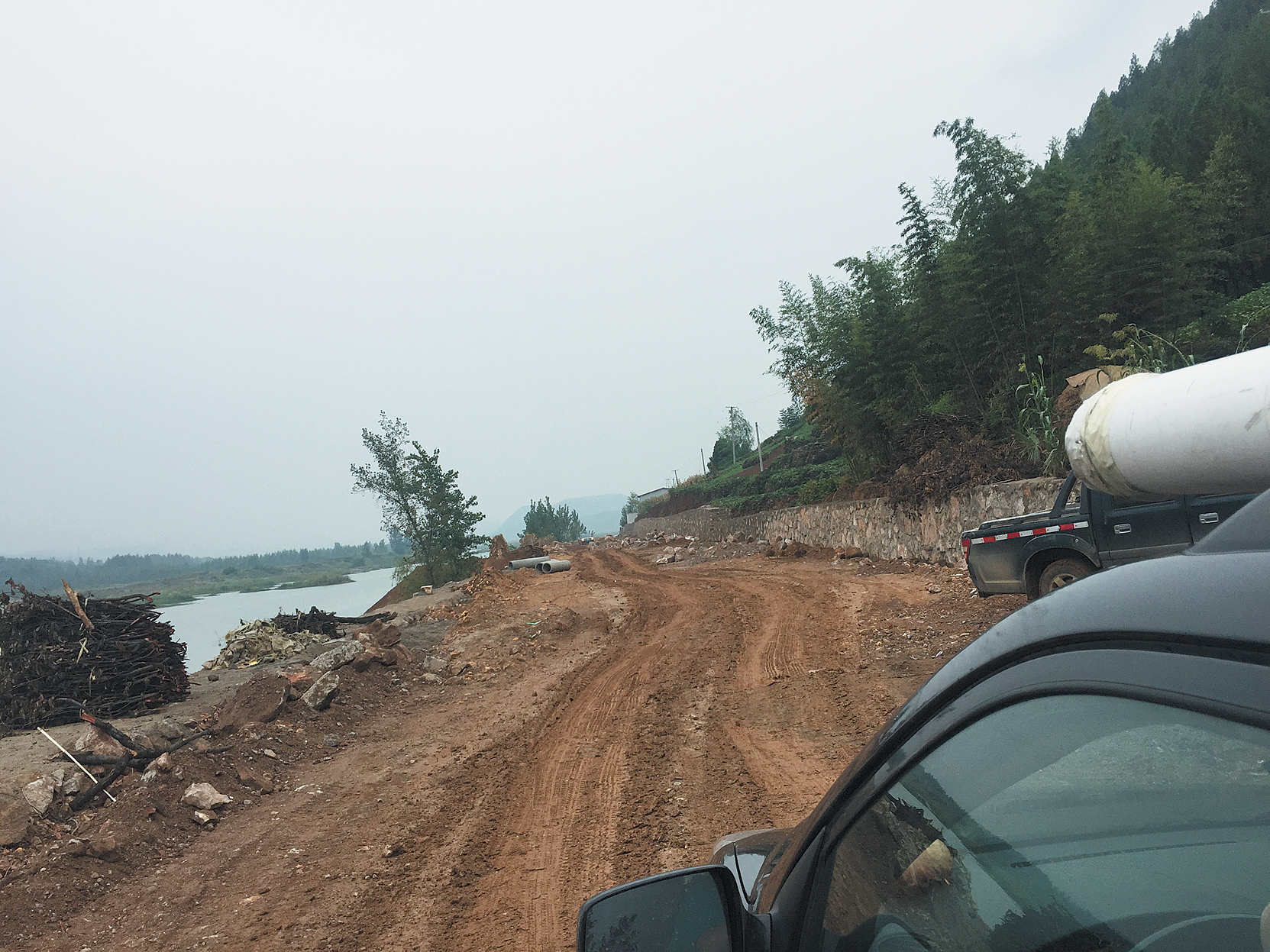 Rutted dirt road along river
