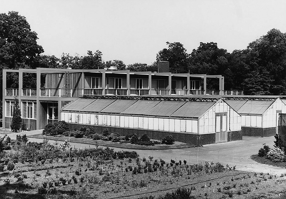 A black and white photo of a greenhouse.