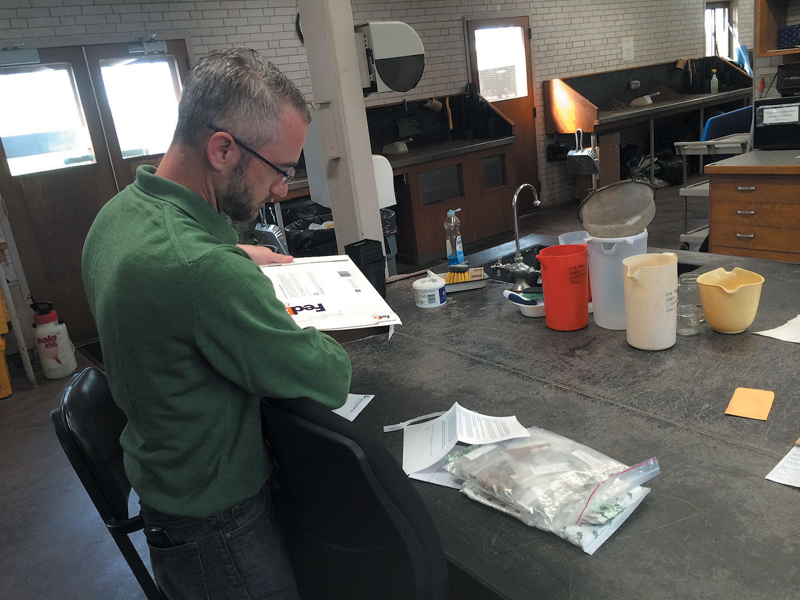 A color photo of a man working in a lab.