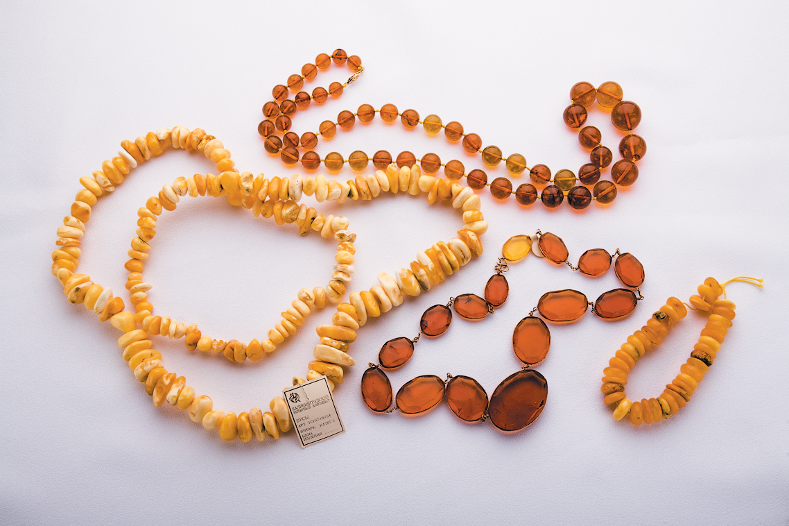 A color photo of several articles of amber jewelry.