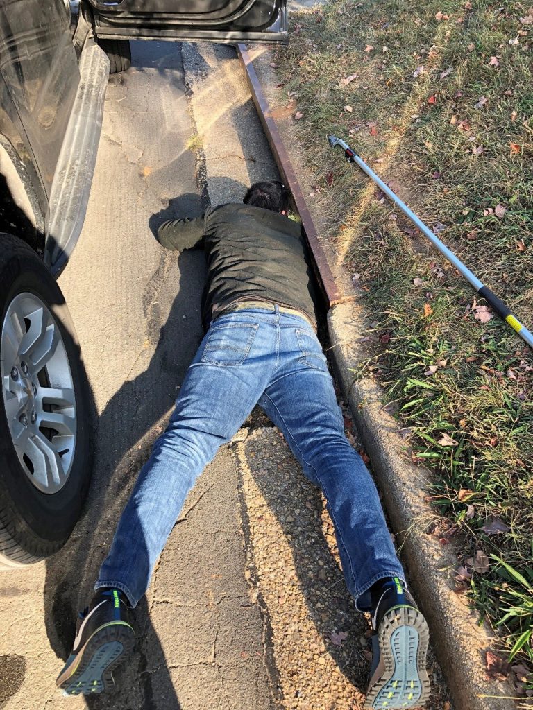 Retrieving a water bottle from a Washington sewer