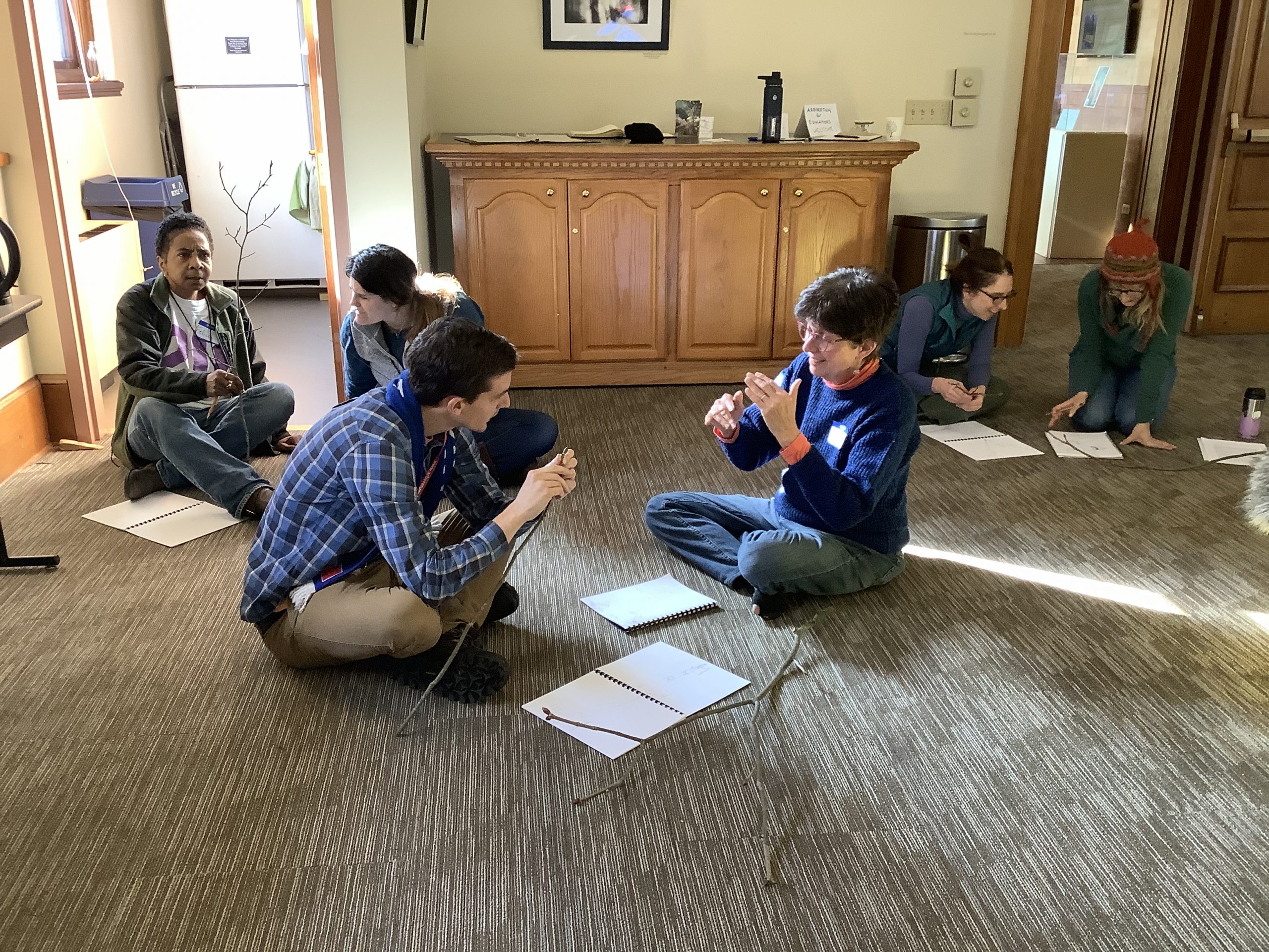 Pairs of teachers discuss their twig drawings and observations.