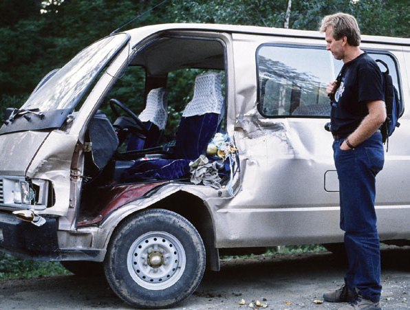 Photo of man inspecting doorless van