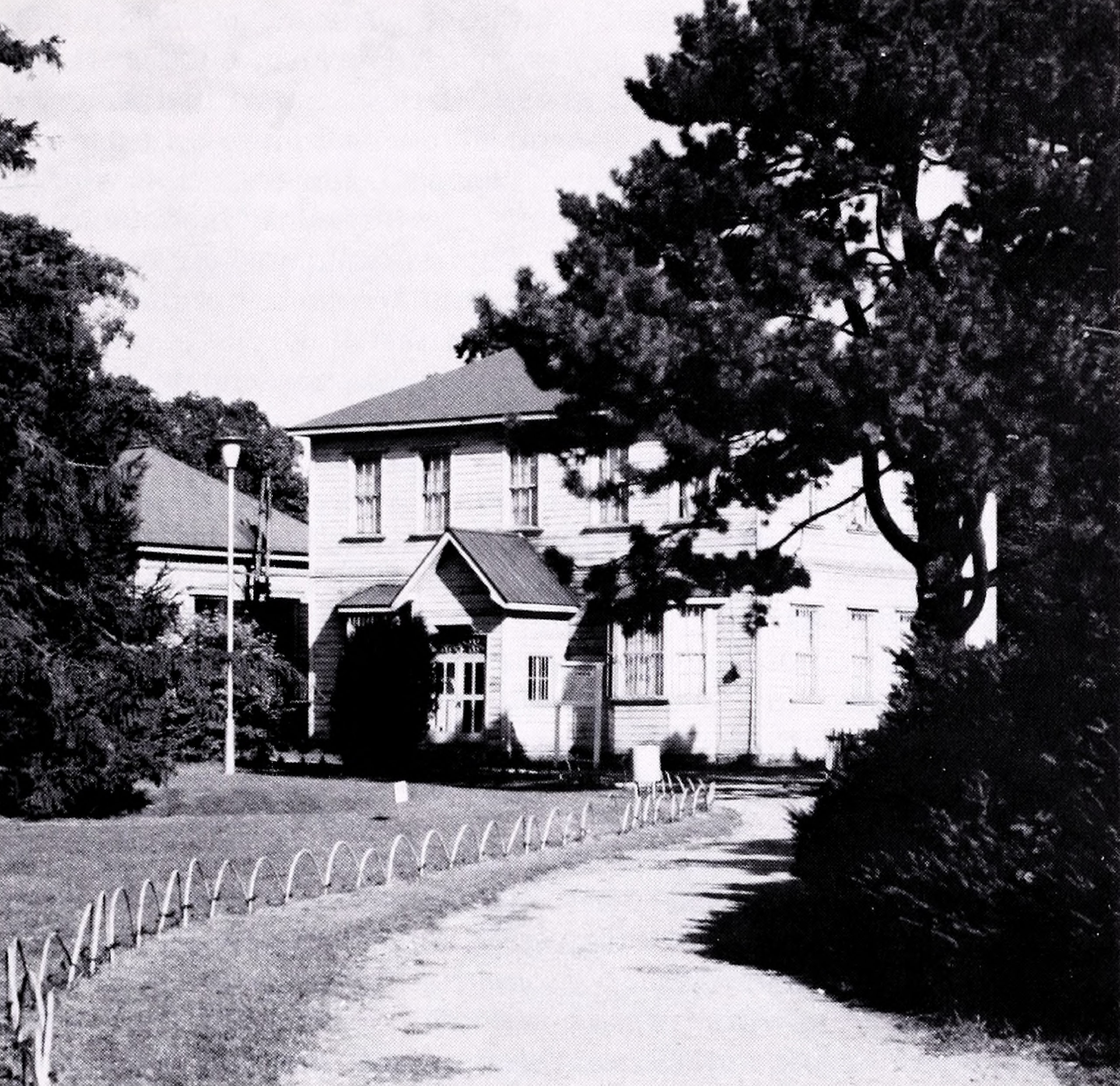 Black-and-white photograph of white farmhouse