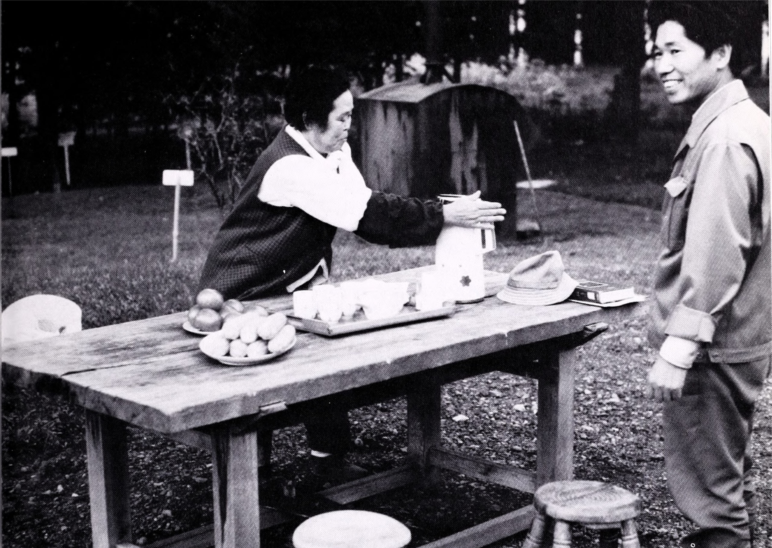 Black-and-white photograph of tea service on wooden table