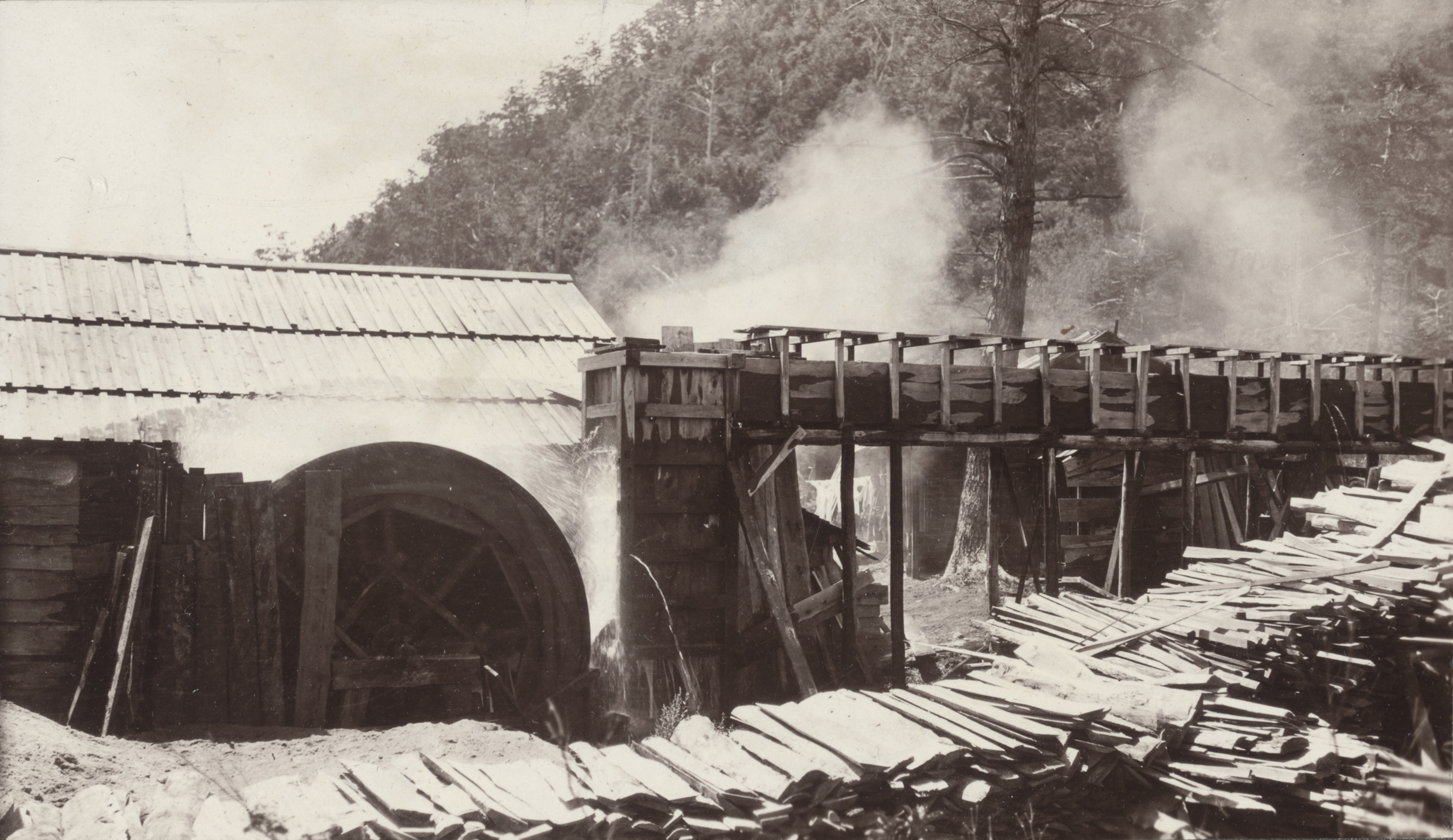 A sawmill being powered by a water wheel near Yumoto, Japan in a photograph by John Jack, August 11, 1905.