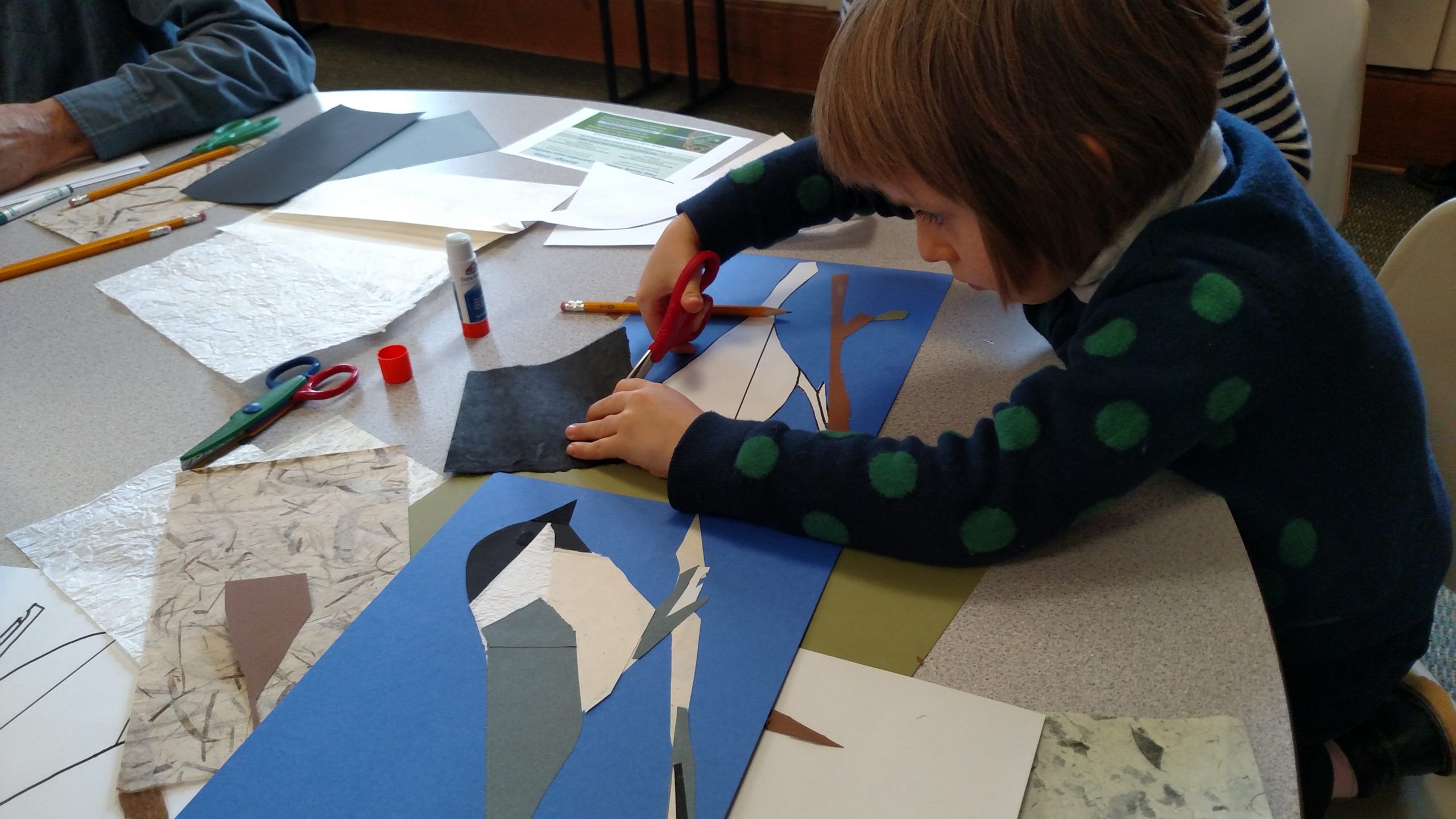 Child making papercraft bird