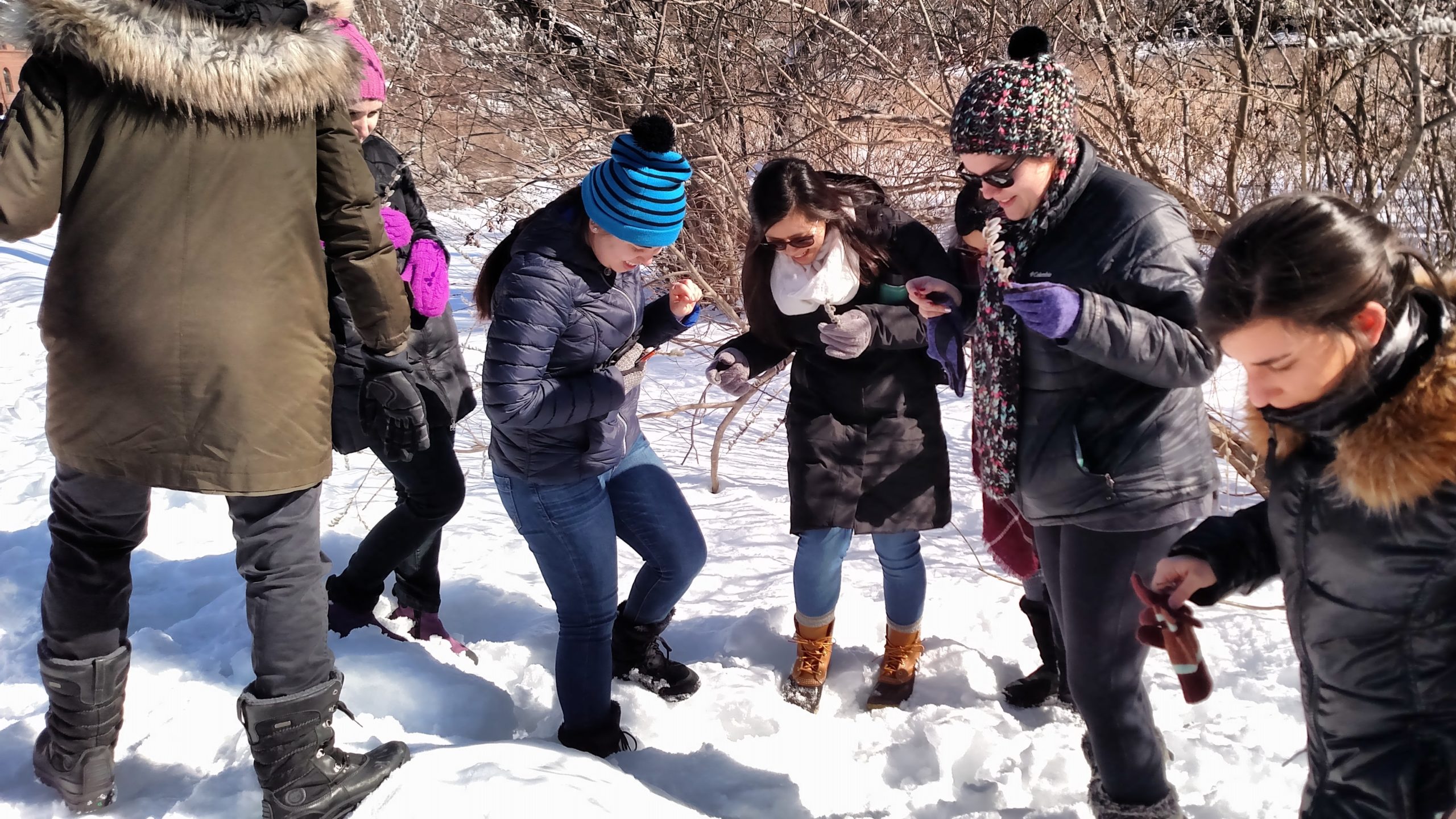 Students examining how deep the snow is