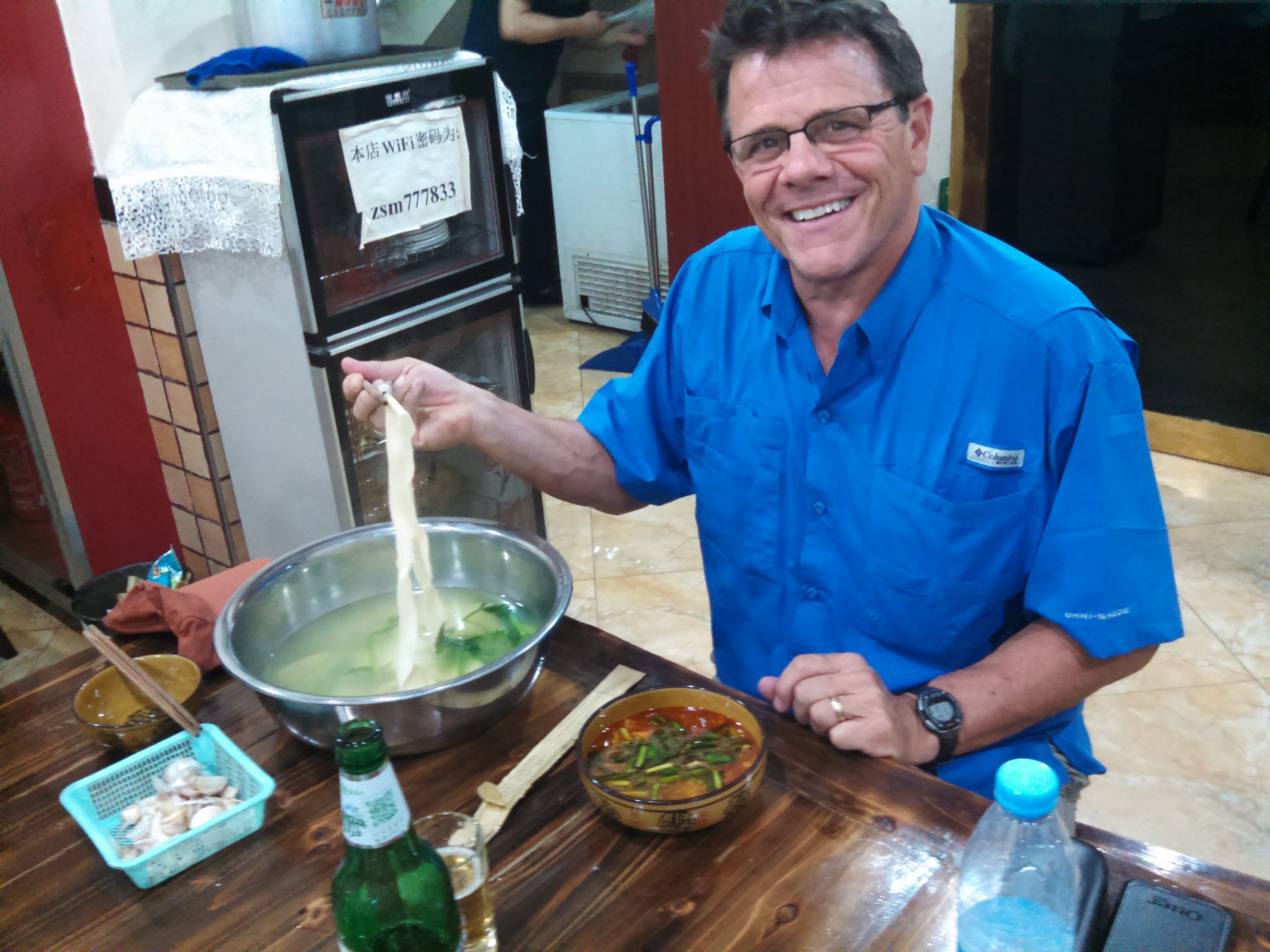 2015 NACPEC team member Kris Bachtell digs into a pot of noodles in China.