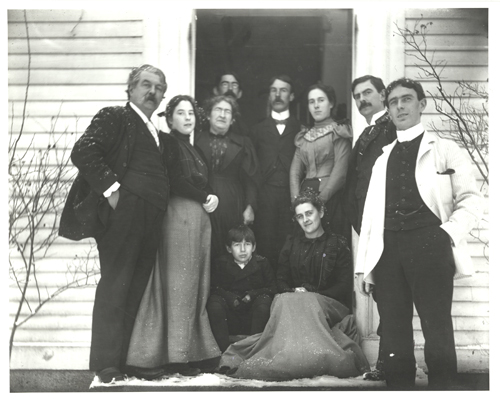 The Dawson Family at their 1090 Centre Street residence, circa 1901. Standing left to right: Jackson Dawson, daughter Laura Blanchard, wife Bessie Minnie, George Walter, Charles Jackson, daughter Minnie Motley Blossom, William Francis, and James Frederick. Seated left to right: Henry (Harry) Sargent, Julia Elizabeth Hoffman Dawson (wife of William Francis).