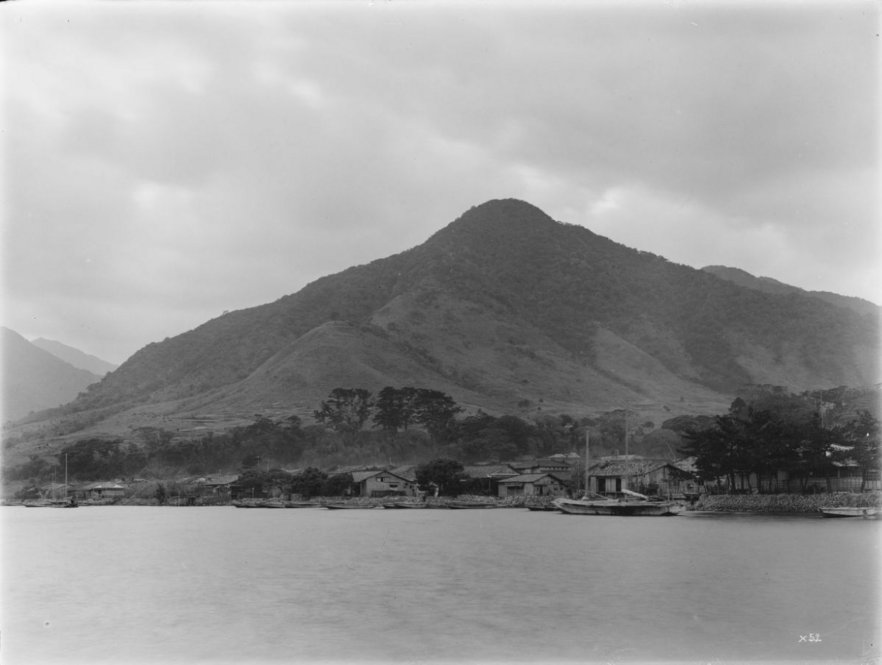 Yakushima [Title from label in photograph album.] Alternate Title: Village by water with hill behind. Village of Miyanoura. Yakushima, 90 miles south of Kagoshima. [Information from label in photograph album.]