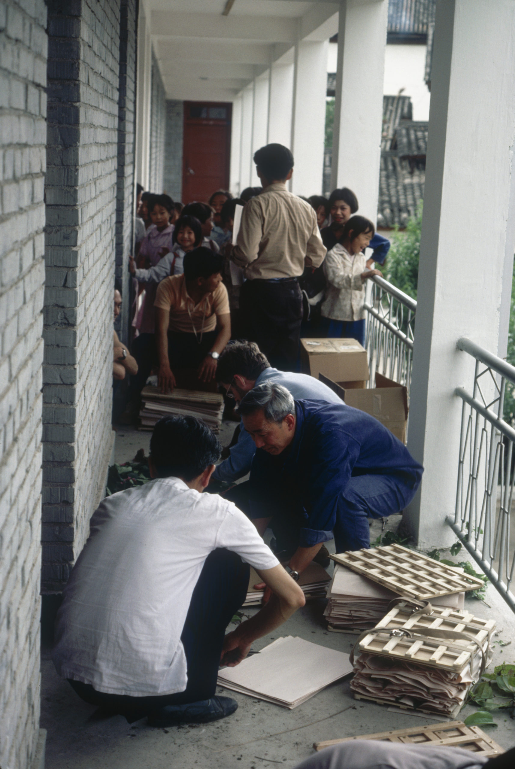 1984 SABE field team members processing the first day's collections in Yangbi (Shangjie) as local children look on.