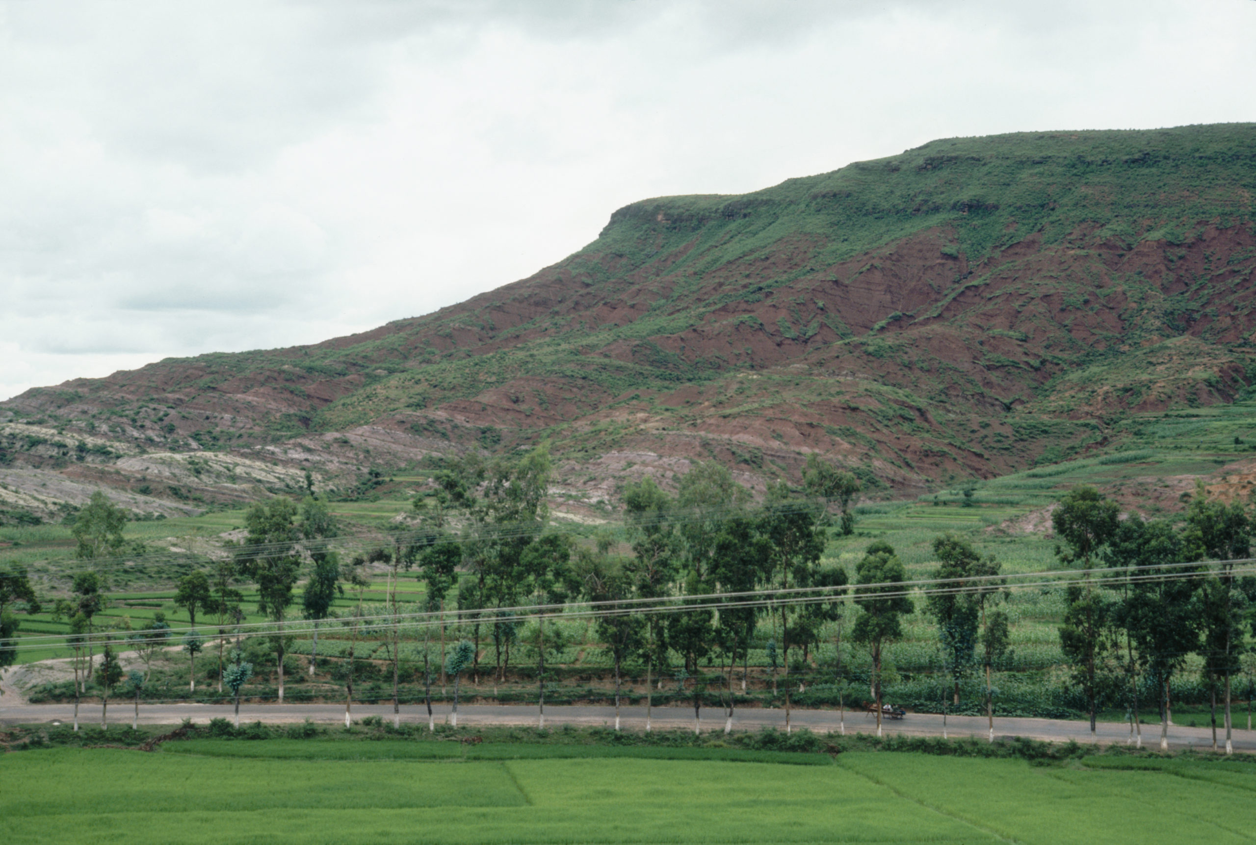Badly eroded, shaley ridges nearly devoid of vegetation at about the 55-mile point (kilometer marker 90) on the Burma Road near Yangjianzhuan, Yunnan.