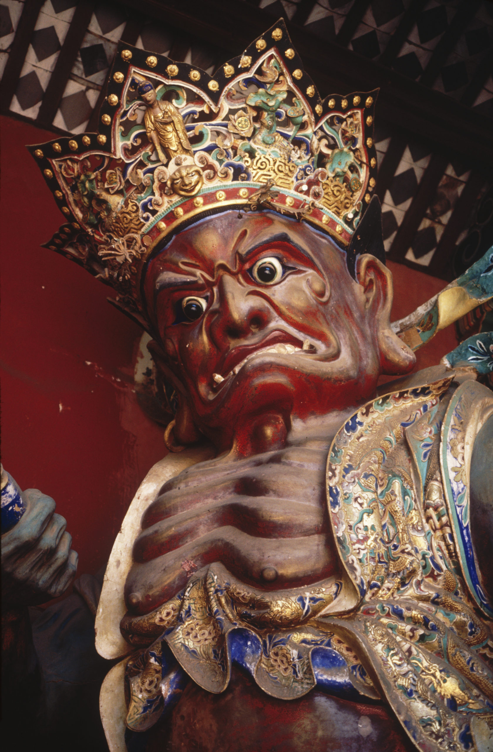 Detail of a statue of a guardian figure at the Huating Temple, Kunming, Yunnan.