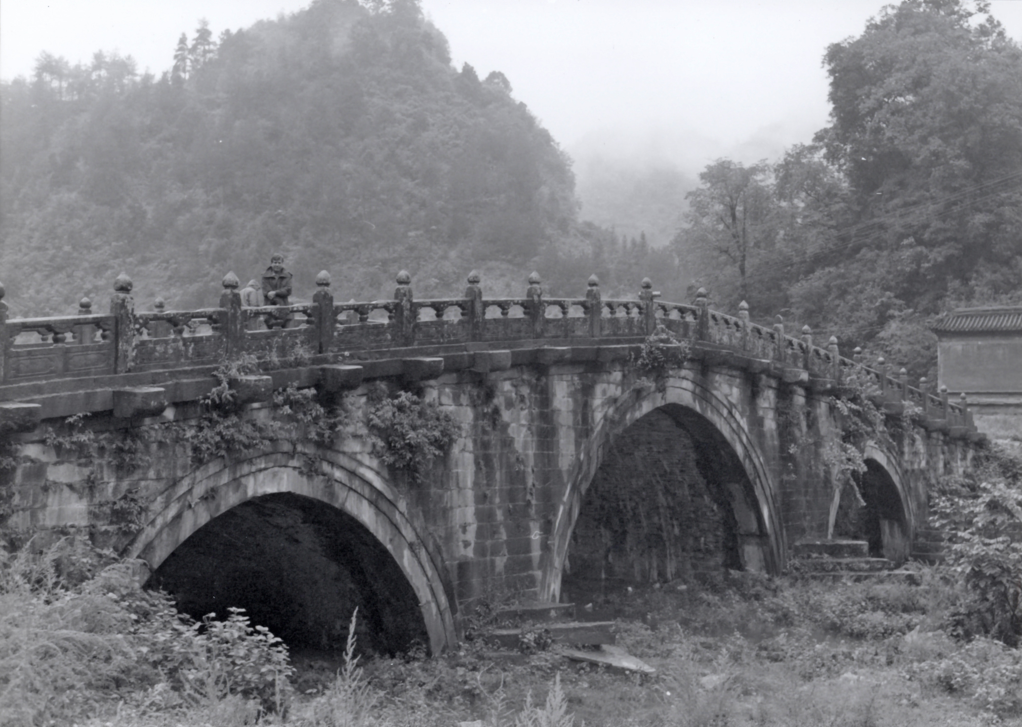 A low stone footbridge with three arches.
