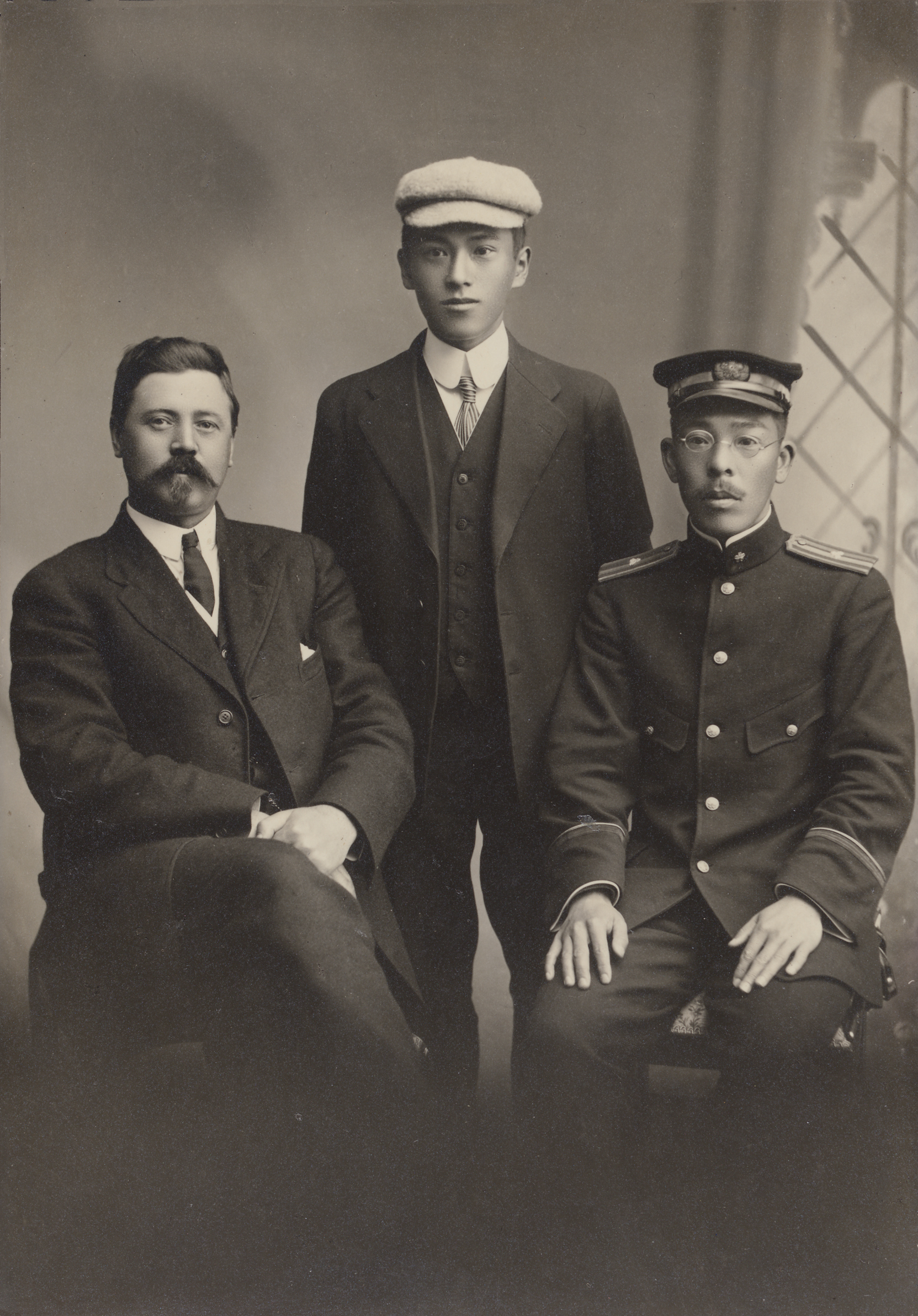 Ernest Wilson (left), with Miyoshi, T. (center), and Ushio, H. (right). This studio portrait was presented to Wilson on March 17, 1917 by the men in Kagoshima, Japan, with the inscription, 