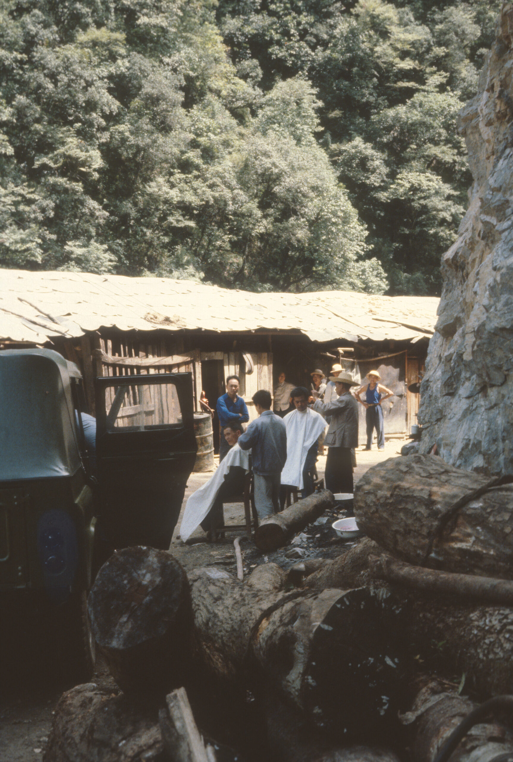 Barbers cutting workers' hair in the Hongriwan Construction Camp, Shennongjia.