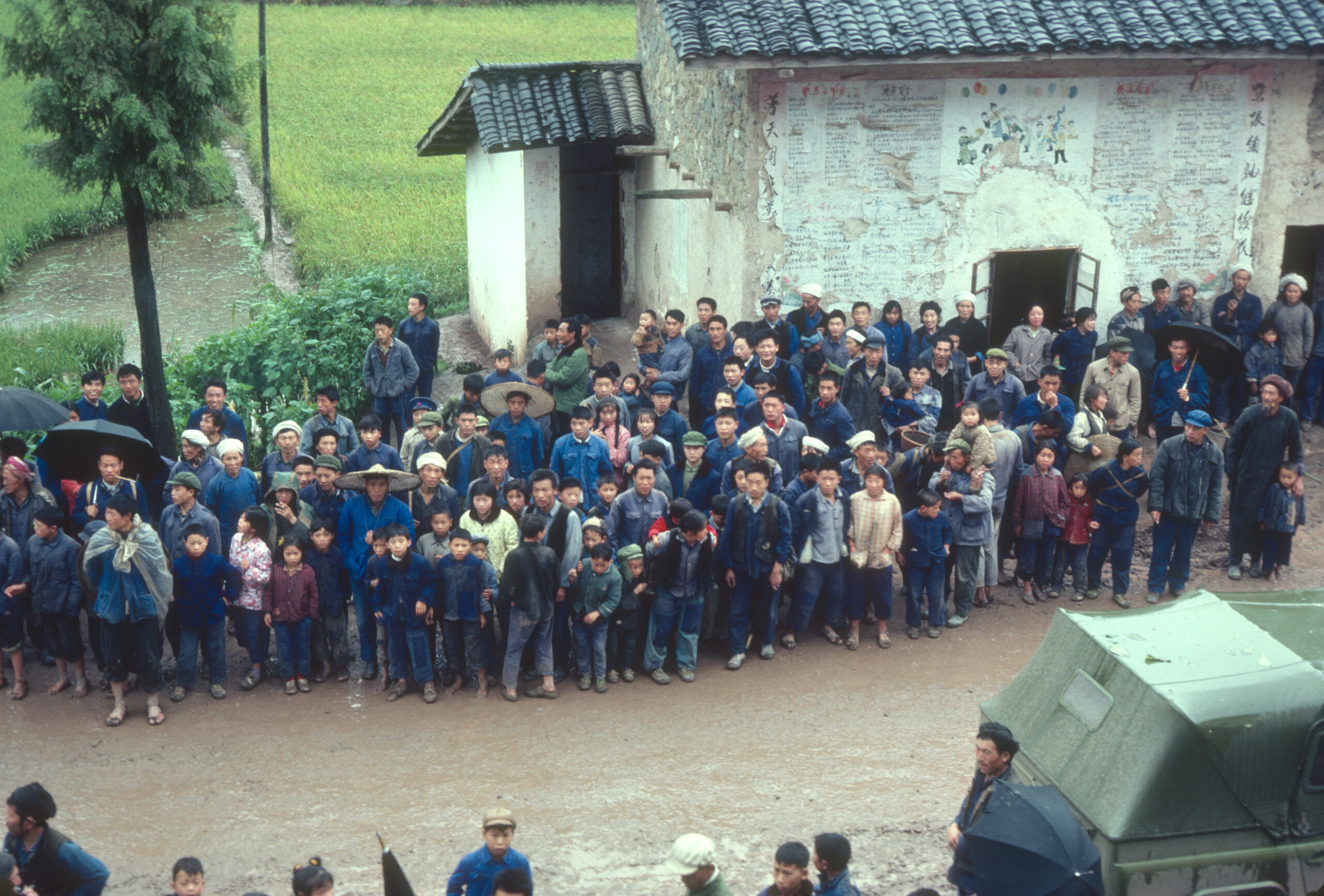 The residents of Modaoqi observing the S.A.B.E. team as they come into the village.