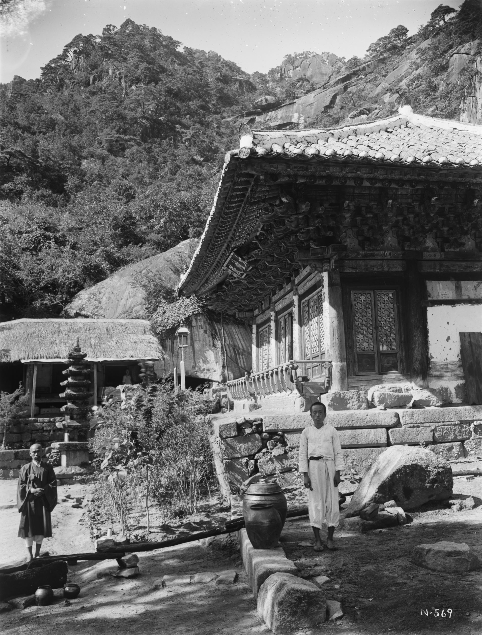 Kwannon temple with 1000 foot (305 meter) cliffs, clothed with Japanese red pine (Pinus densiflora). In the mountains beyond Keijyo, Keiki Province. Photograph by Ernest Wilson, August 1918.