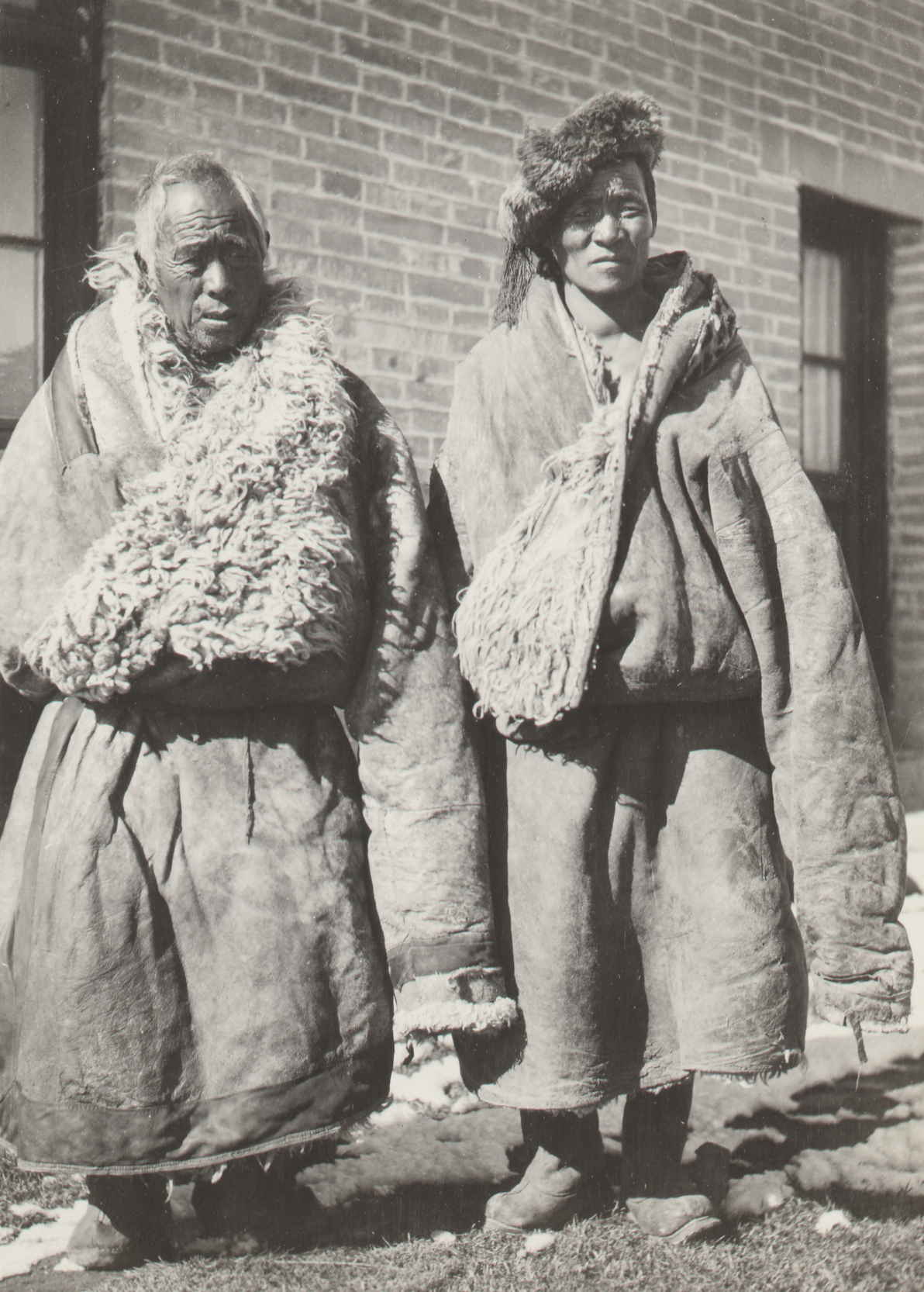 Men from the Gansu-Tibet borderlands in traditional dress of long fur lined robes. Photograph by William Purdom, 1911.