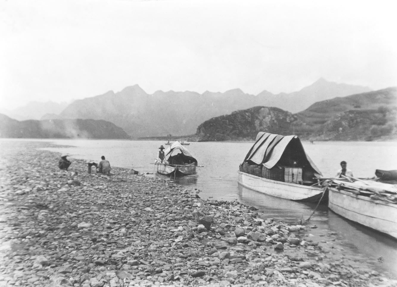 Black-and-white photograph of boats on river
