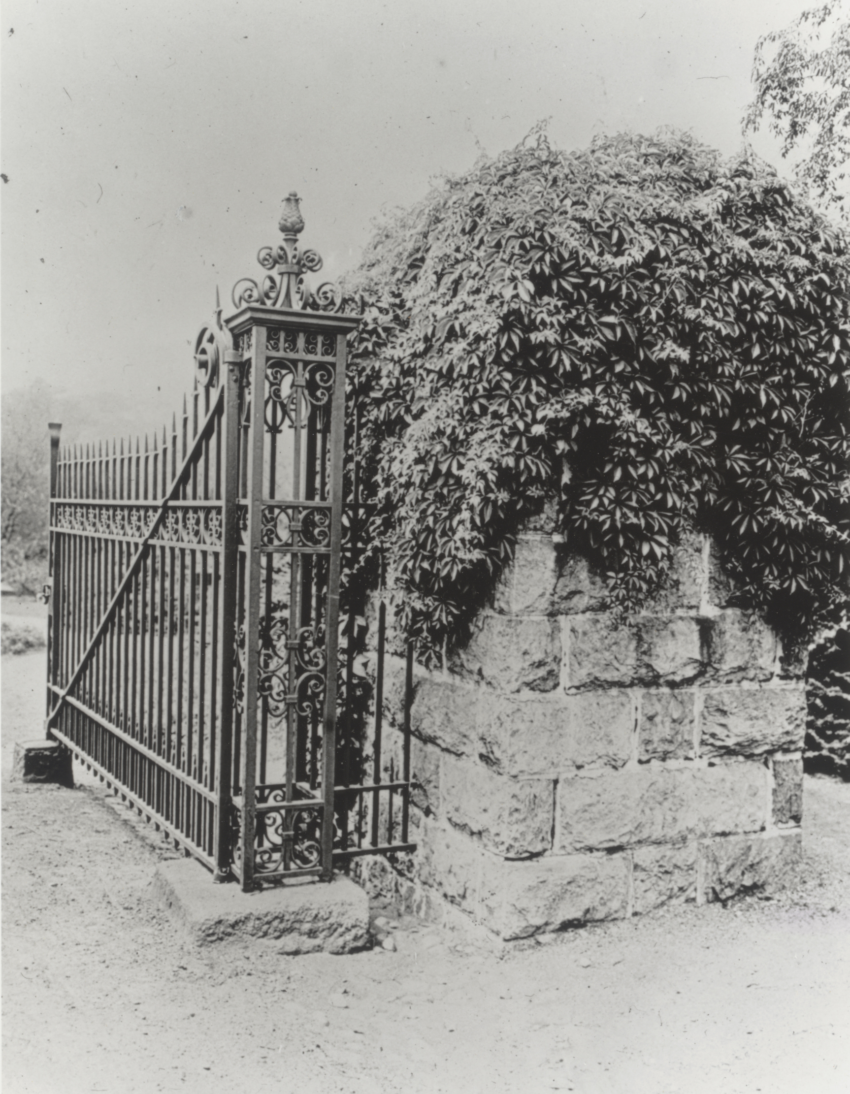 Iron gate and stone pier of the Arborway Gate of the Arnold Arboretum, ca. 1916.