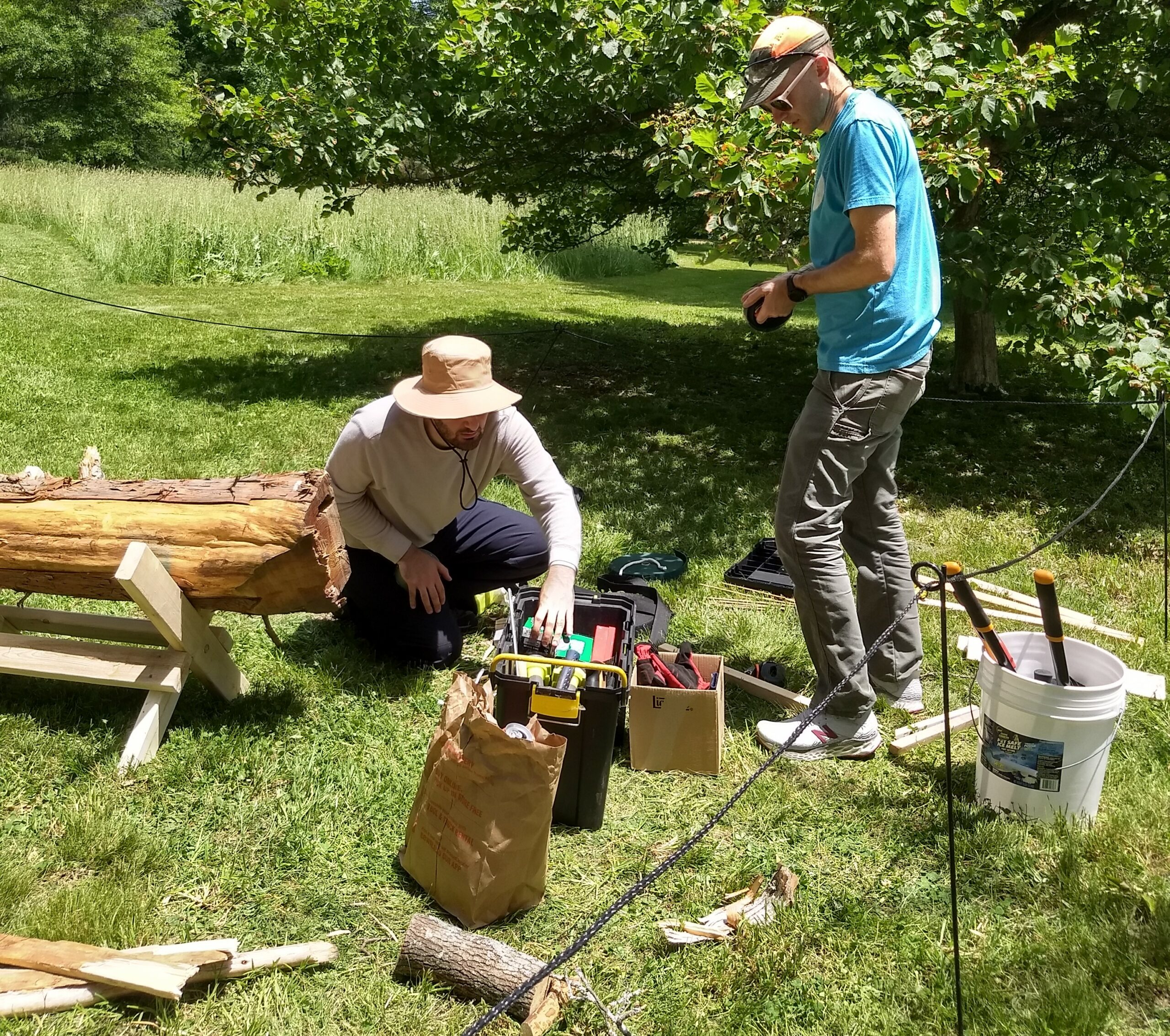Two men working with tools and pieces of wood