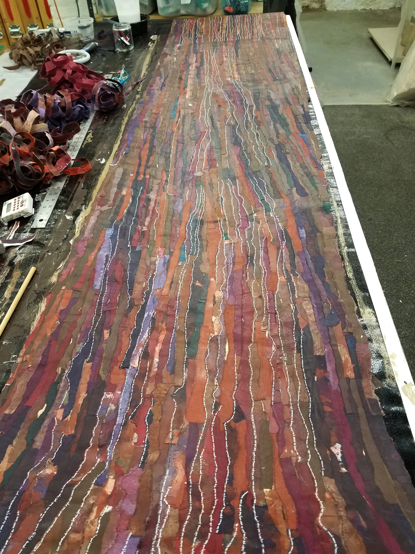 art scroll stretched out, vaious materials, colors, tiny script