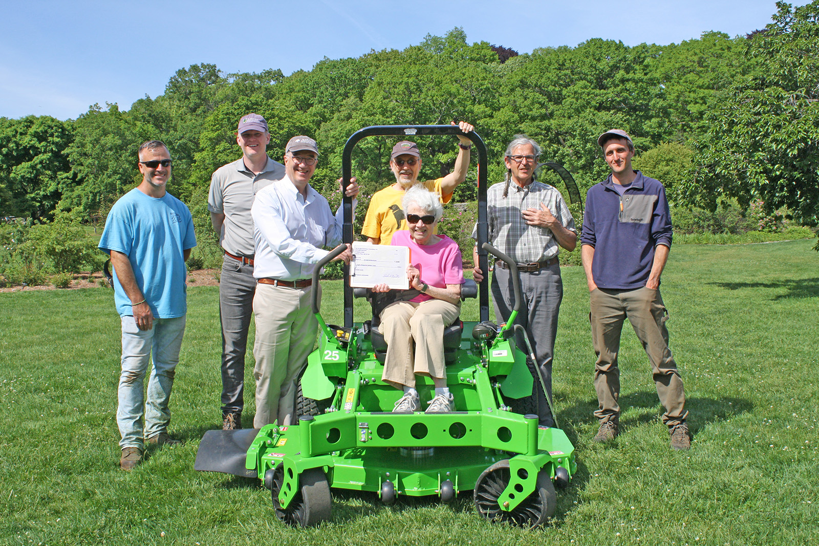 Members of the Arnold Arboretum Committee and Arboretum staff celebrate AAC's gift of an electric mower