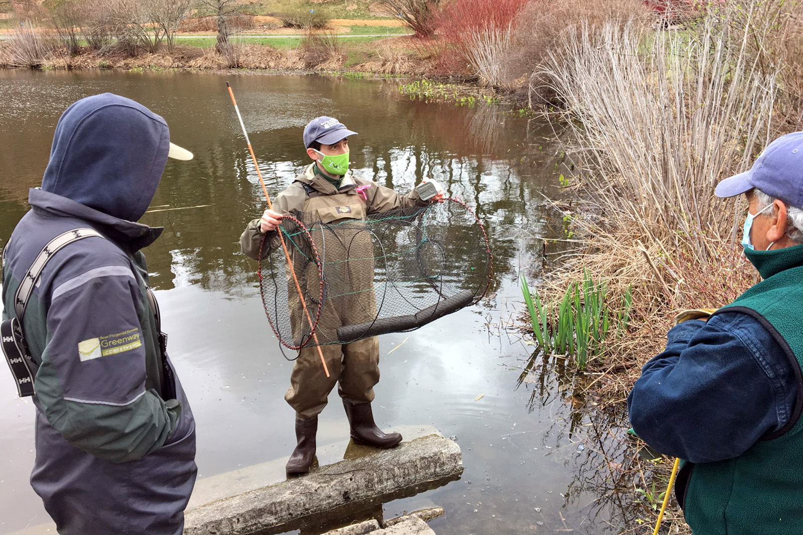 Matt Kamm deploys a trap to capture and relocated turtles in Rehder Pond