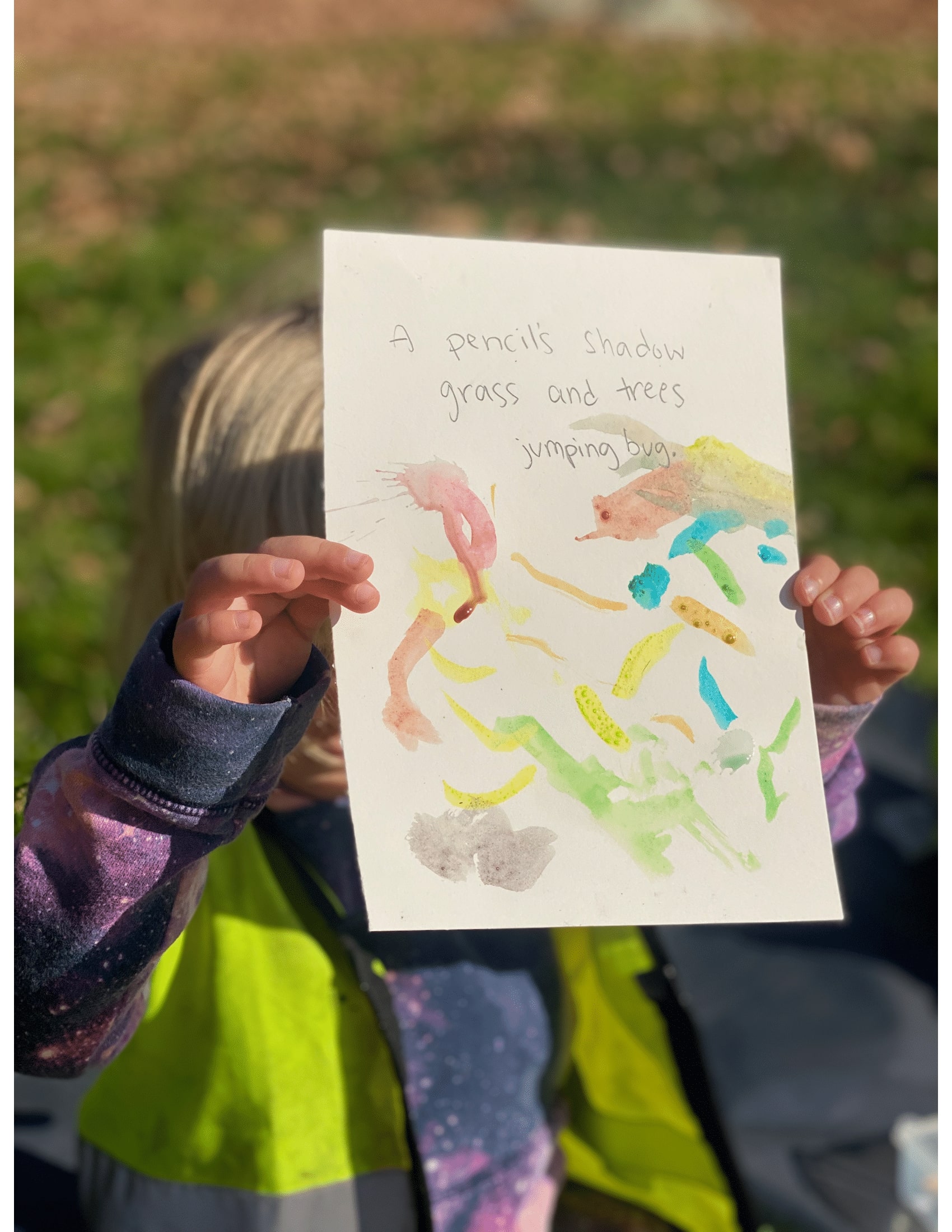 Kid holding a haiku that reads 