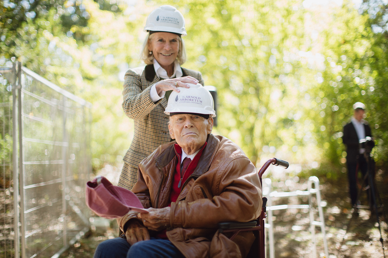 RoAnn Costin places a hardhat on the head of her father, Thomas Costin Jr., at the groundbreaking for Poplar Gate renovations.